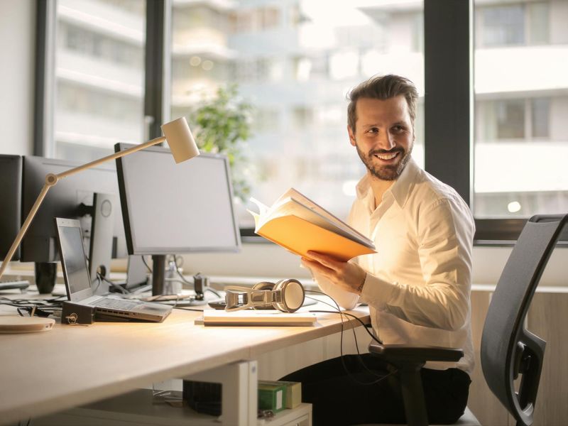 Person sitting calmly in a modern office near window
